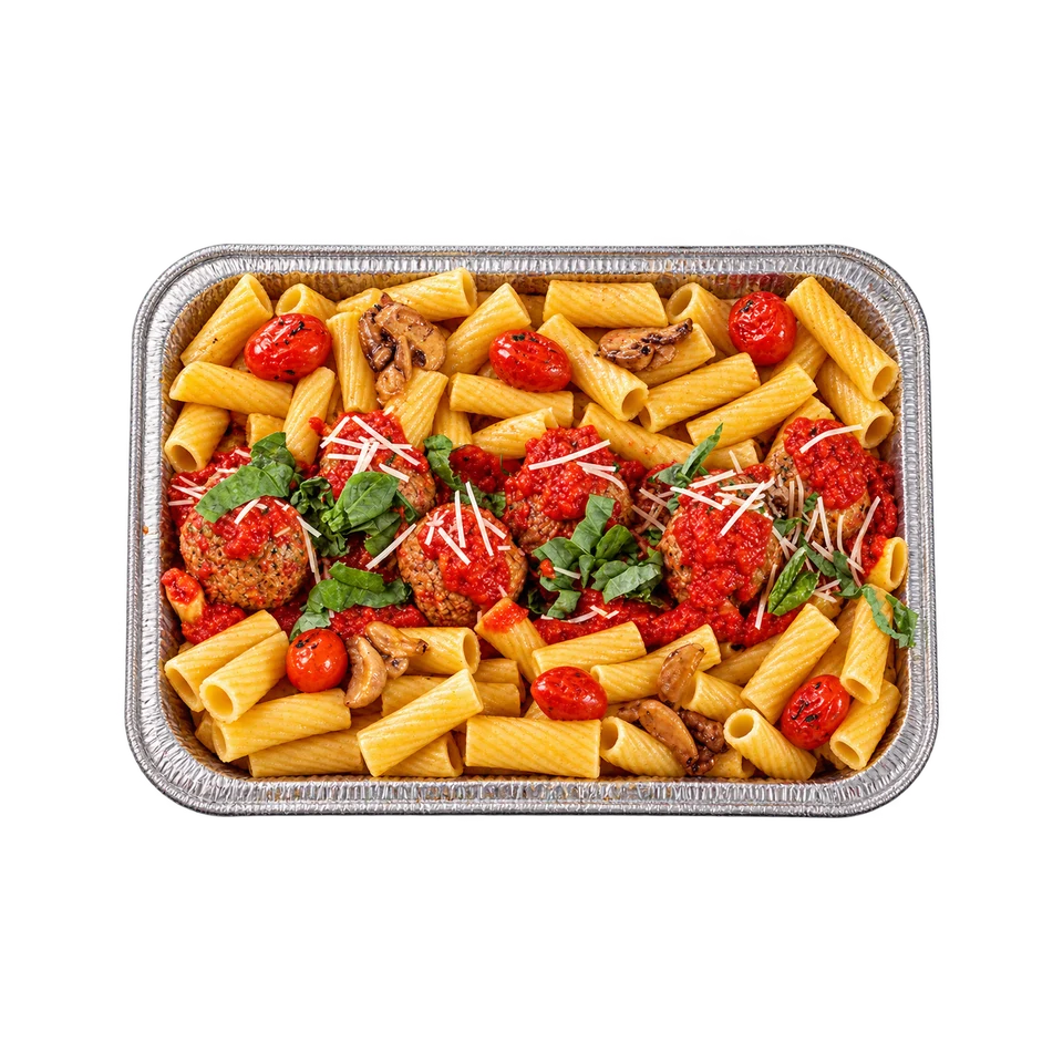 Rigatoni pasta with meatballs, tomatoes and herbs in a foil catering tray
